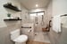 universal design bathroom with curbless shower, matte black fixures, grab bars, and shower seating by Imagine Remodeling in Fresno