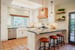 Kitchen in CA By Imagine Remodeling with island and pendant lights and warm terra cotta flooring