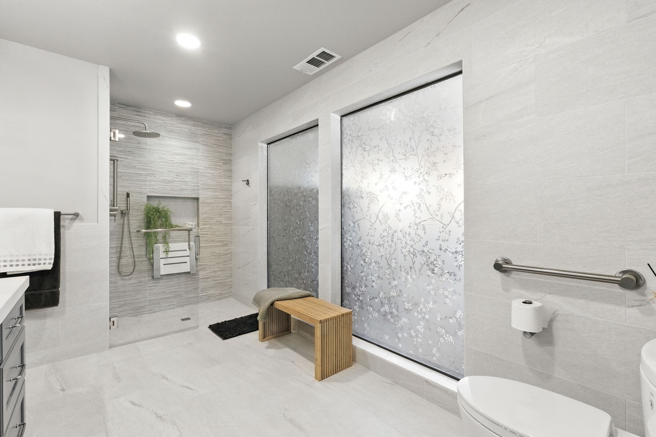 Wide view of modern accessible Fresno bathroom with walk-in shower and frosted windows