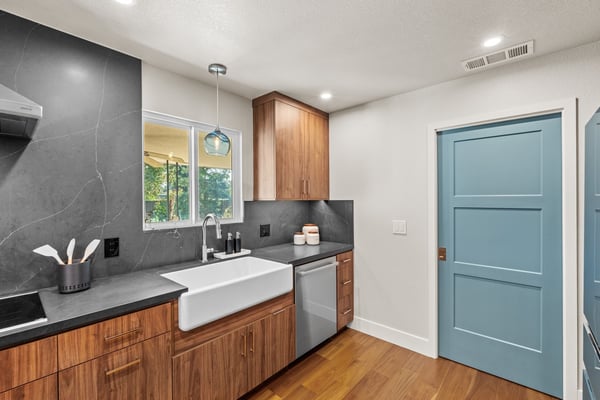Contemporary Fresno kitchen with farmhouse sink, wood cabinets, and blue door Contemporary Fresno kitchen with farmhouse sink, wood cabinets, and blue door