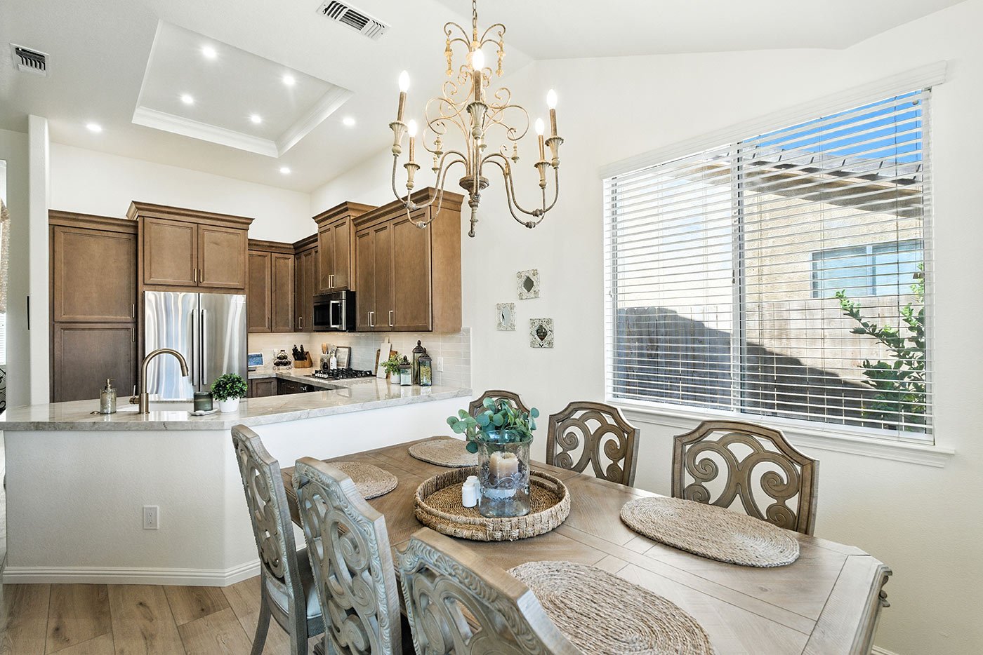 Elegant dining space beside a remodeled Fresno kitchen by Imagine Remodeling with warm wood tones and natural light
