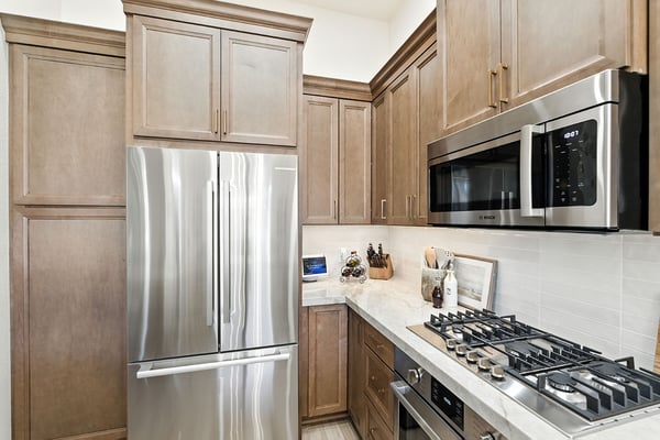 Modern kitchen with wood cabinets, marble countertops, and stainless appliances in Fresno, CA Modern kitchen with wood cabinets, marble countertops, and stainless appliances in Fresno, CA