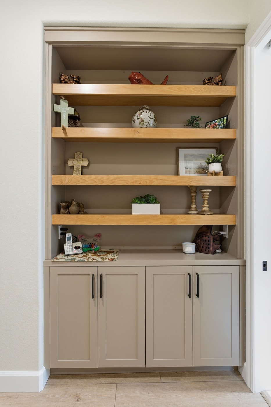 Close-up of built-in shelving with decor and storage cabinets in a Fresno home Close-up of built-in shelving with decor and storage cabinets in a Fresno home