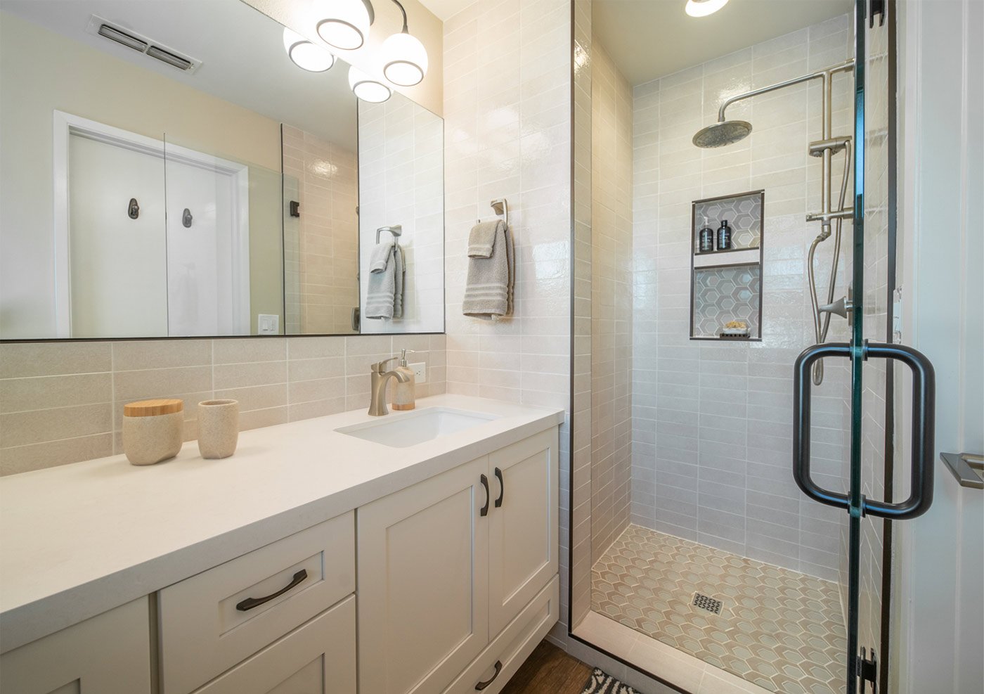 Modern bathroom remodel in Fresno, CA featuring glass shower and beige tile design