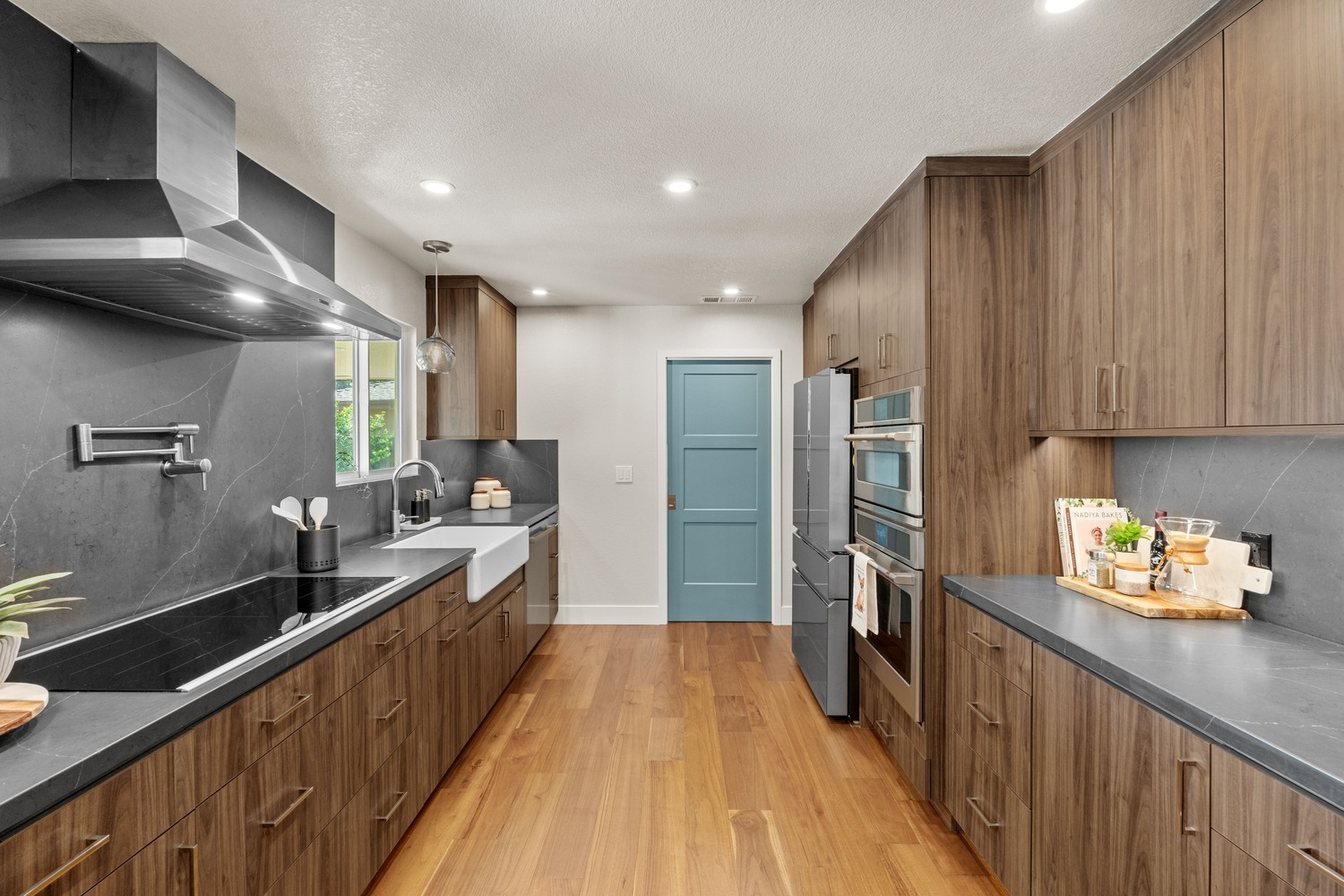 Spacious Fresno kitchen with stainless appliances, wood cabinets, and blue door