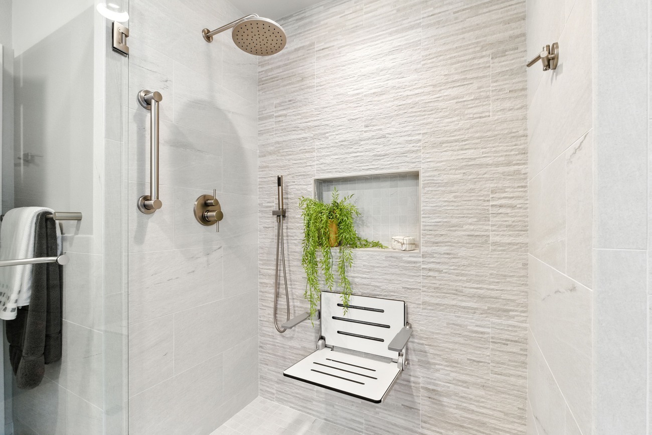 Closeup of walk-in shower floor and fold-down seat in modern Fresno bathroom Closeup of walk-in shower floor and fold-down seat in modern Fresno bathroom