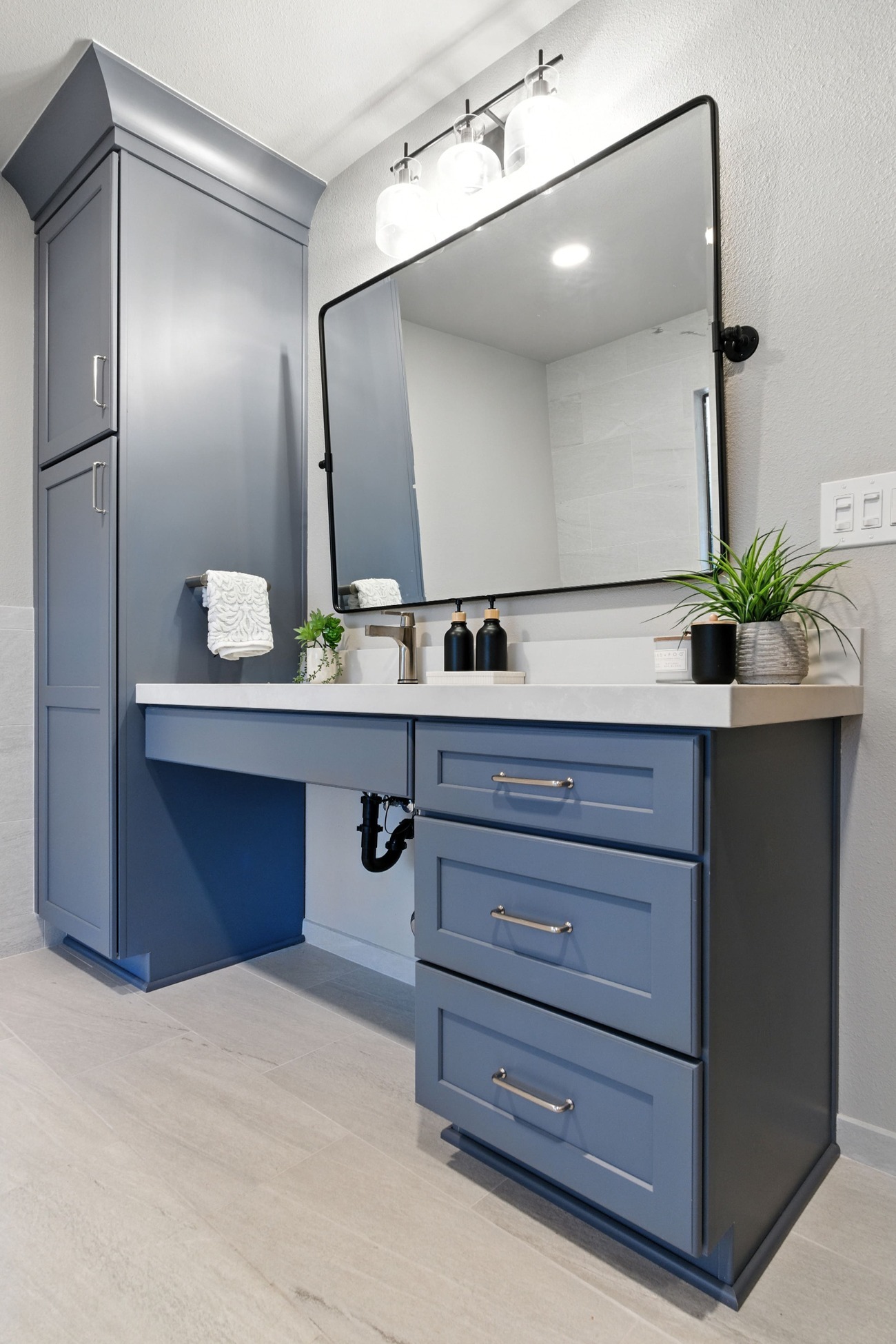 Fresno bathroom vanity with blue cabinets, large mirror, and bright modern lighting Fresno bathroom vanity with blue cabinets, large mirror, and bright modern lighting