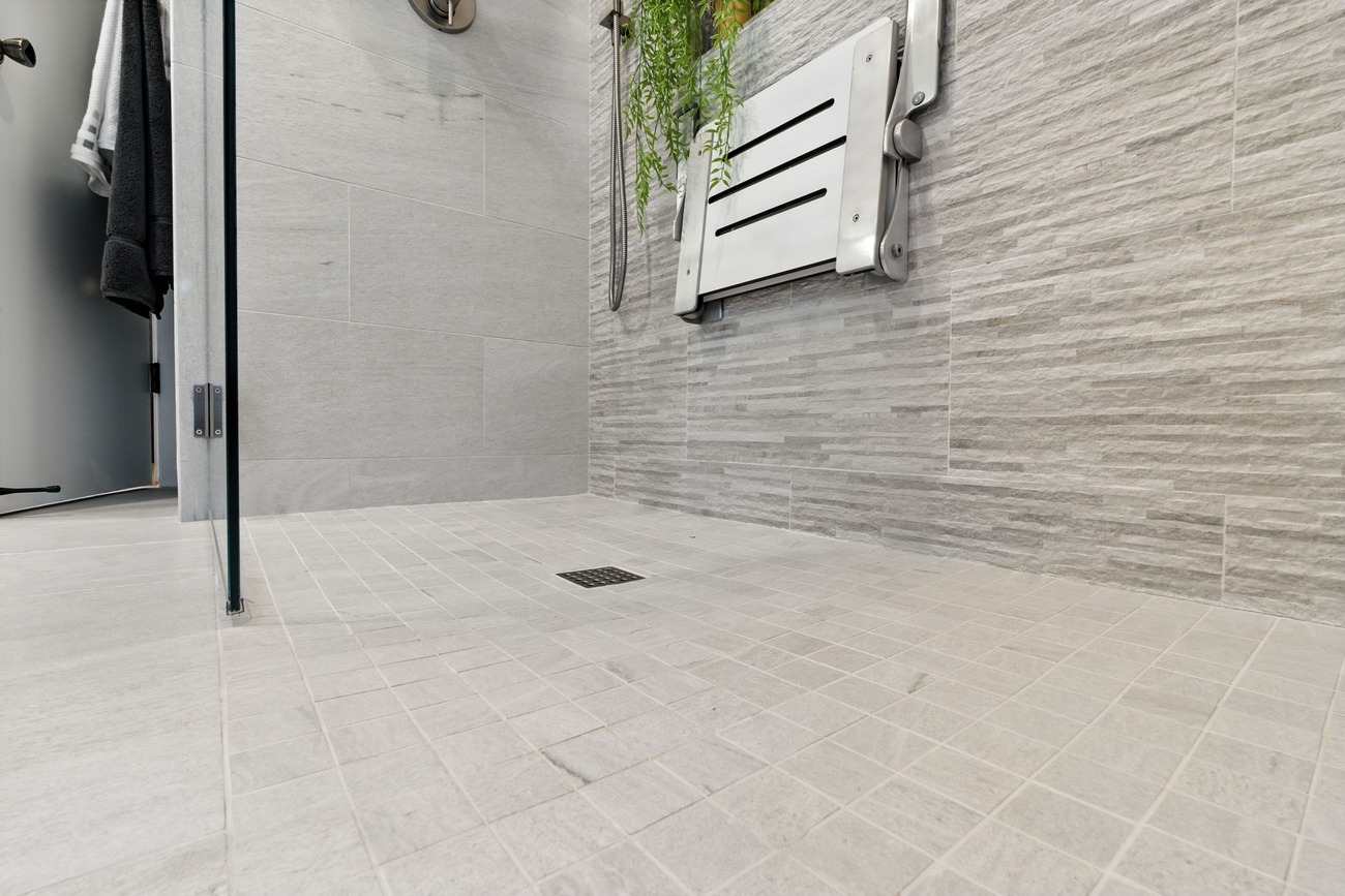 Full Fresno bathroom showing vanity, walk-in shower with seat, and frosted windows Full Fresno bathroom showing vanity, walk-in shower with seat, and frosted windows