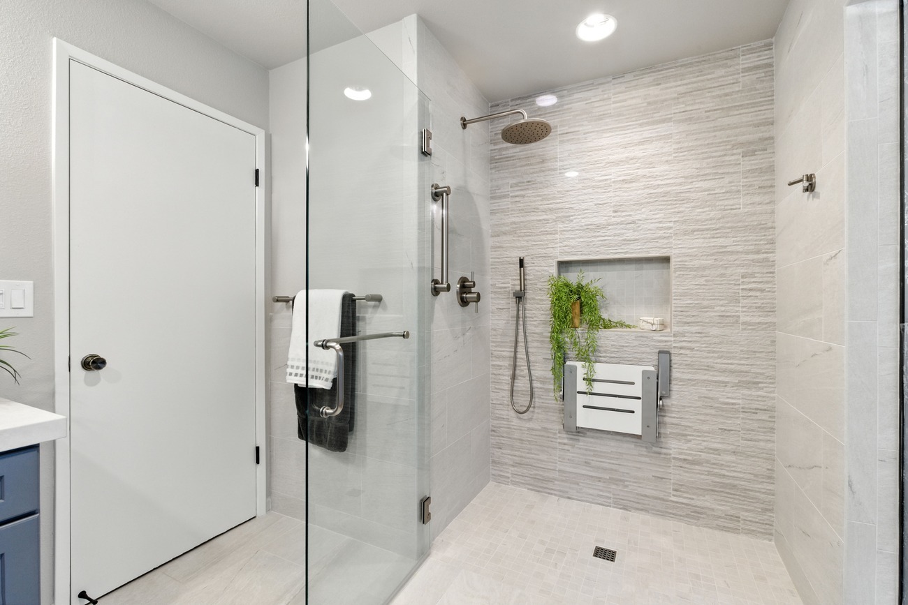 Modern Fresno shower with glass door, grab bars, rainfall head, and tile surround Modern Fresno shower with glass door, grab bars, rainfall head, and tile surround