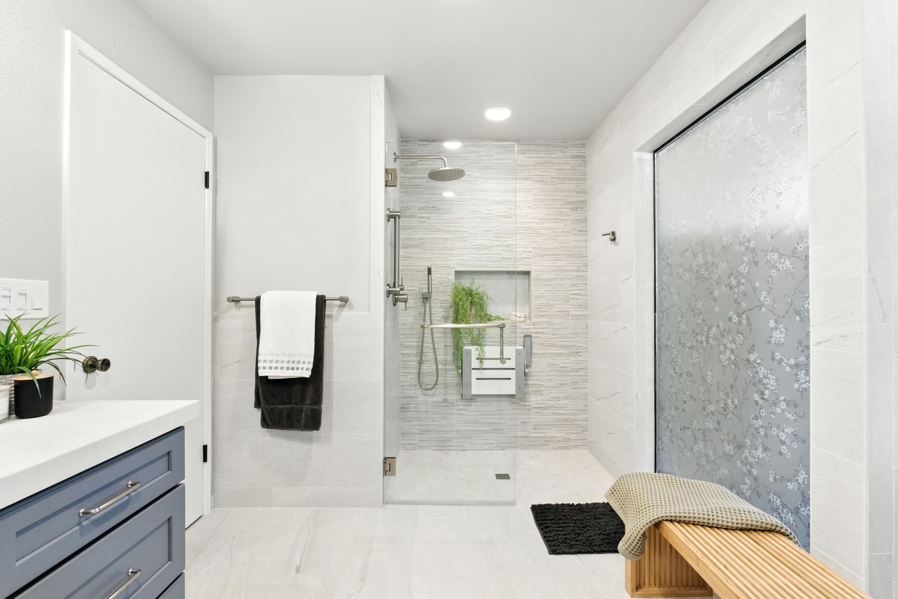 Spacious Fresno bathroom with walk in shower, frosted glass panels, and sleek tile design Spacious Fresno bathroom with walk in shower, frosted glass panels, and sleek tile design