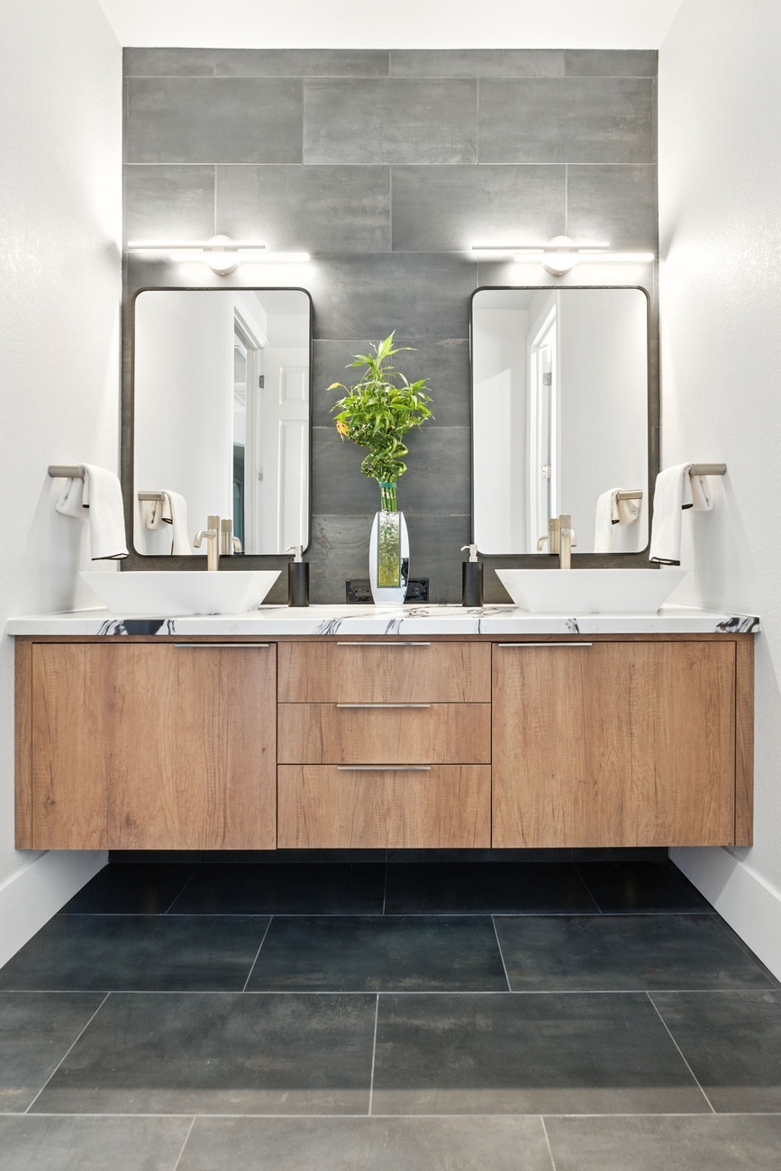 Fresno double vanity with wood cabinets, vessel sinks, and tall dark tile backdrop