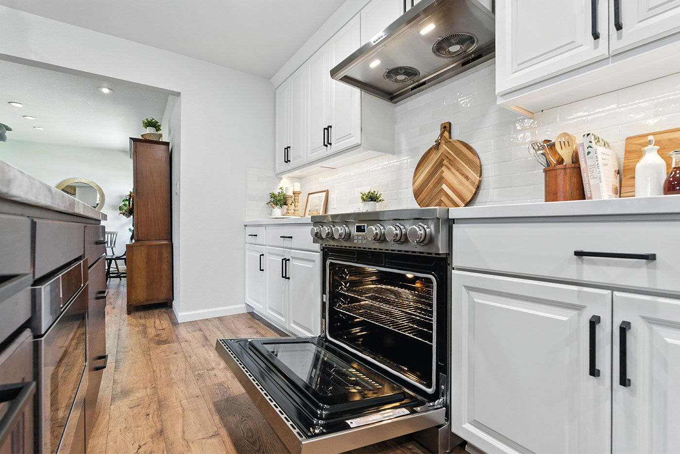 Clovis kitchen with white cabinets, wood floors, and a stainless steel oven by Imagine Remodeling Clovis kitchen with white cabinets, wood floors, and a stainless steel oven by Imagine Remodeling