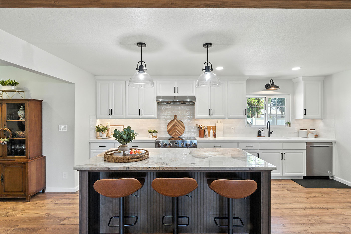 Spacious kitchen with marble island, bar seating, and white cabinets in Clovis, CA Spacious kitchen with marble island, bar seating, and white cabinets in Clovis, CA