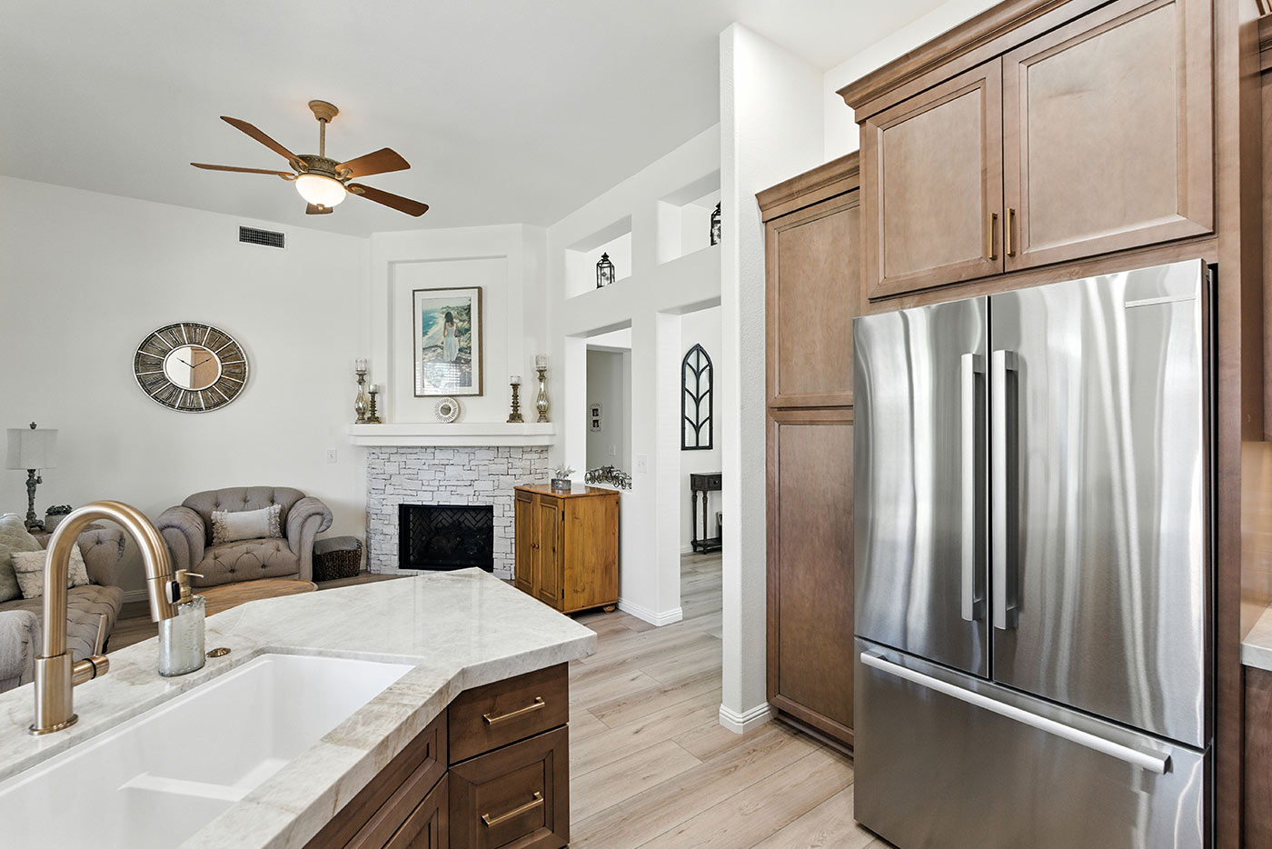 Cozy living room and kitchen view with fireplace and marble countertops in Fresno, CA