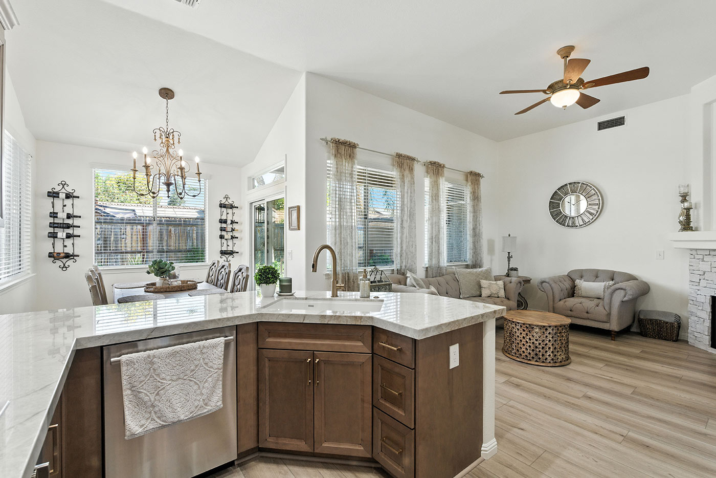 Open-concept kitchen and living area with marble counters and neutral décor in Fresno, CA